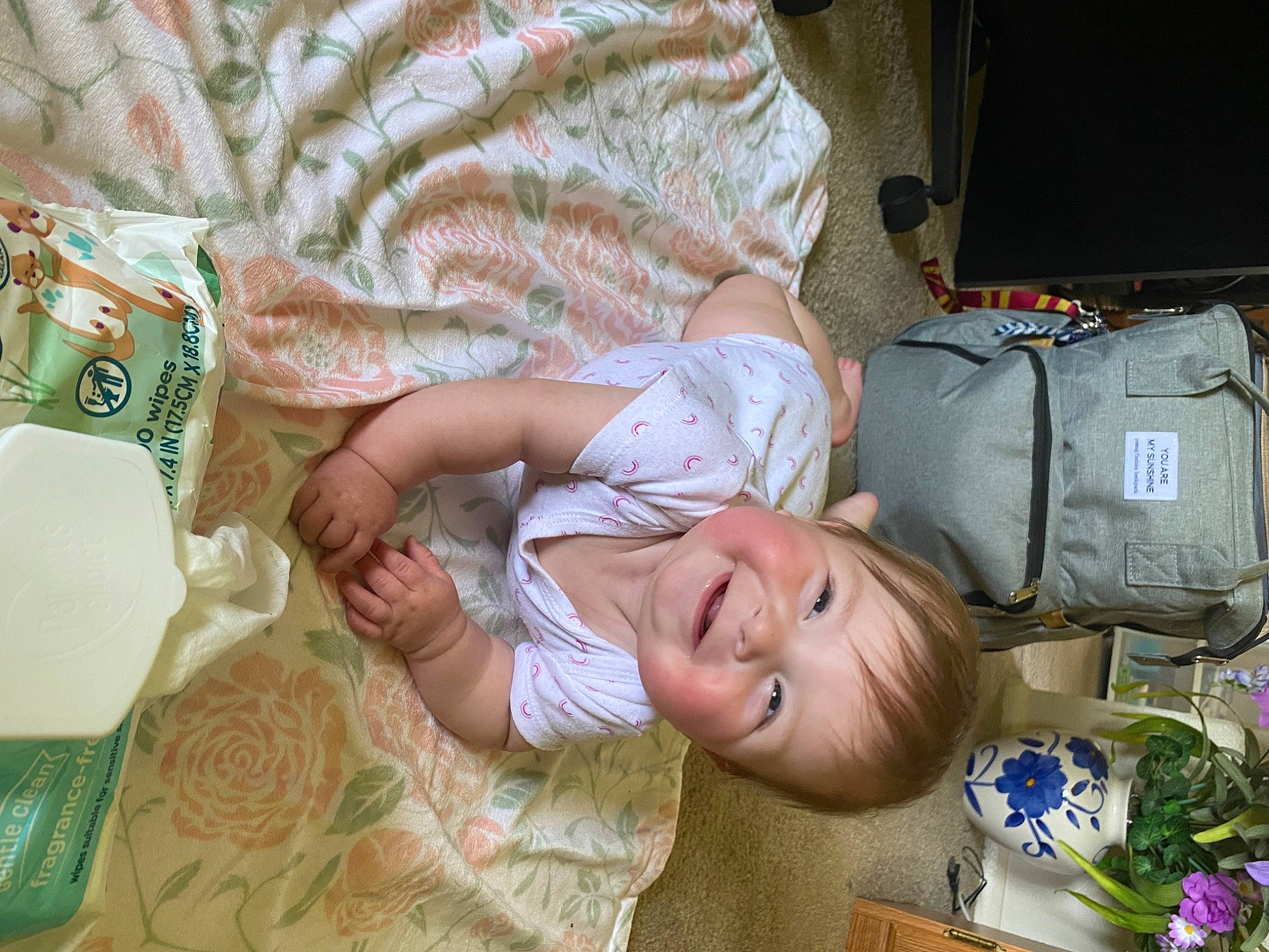 Alivia is registered to the contest to win money with this photo: baby, baby_toddler_clothing, backpack, bag, child, comfort, eye, flower, grass, green, happy, hat, joy, luggage_and_bags, pattern, person, plant, sitting, smile, toddler