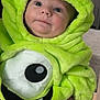 Hudson joined the competition — help win amazing prizes! baby, child, costume, plush, green, purple, monster, hood, indoors, cute, face, expression, sitting, soft_lighting, clothing, person, infant, smile, chubby_cheeks, eyes