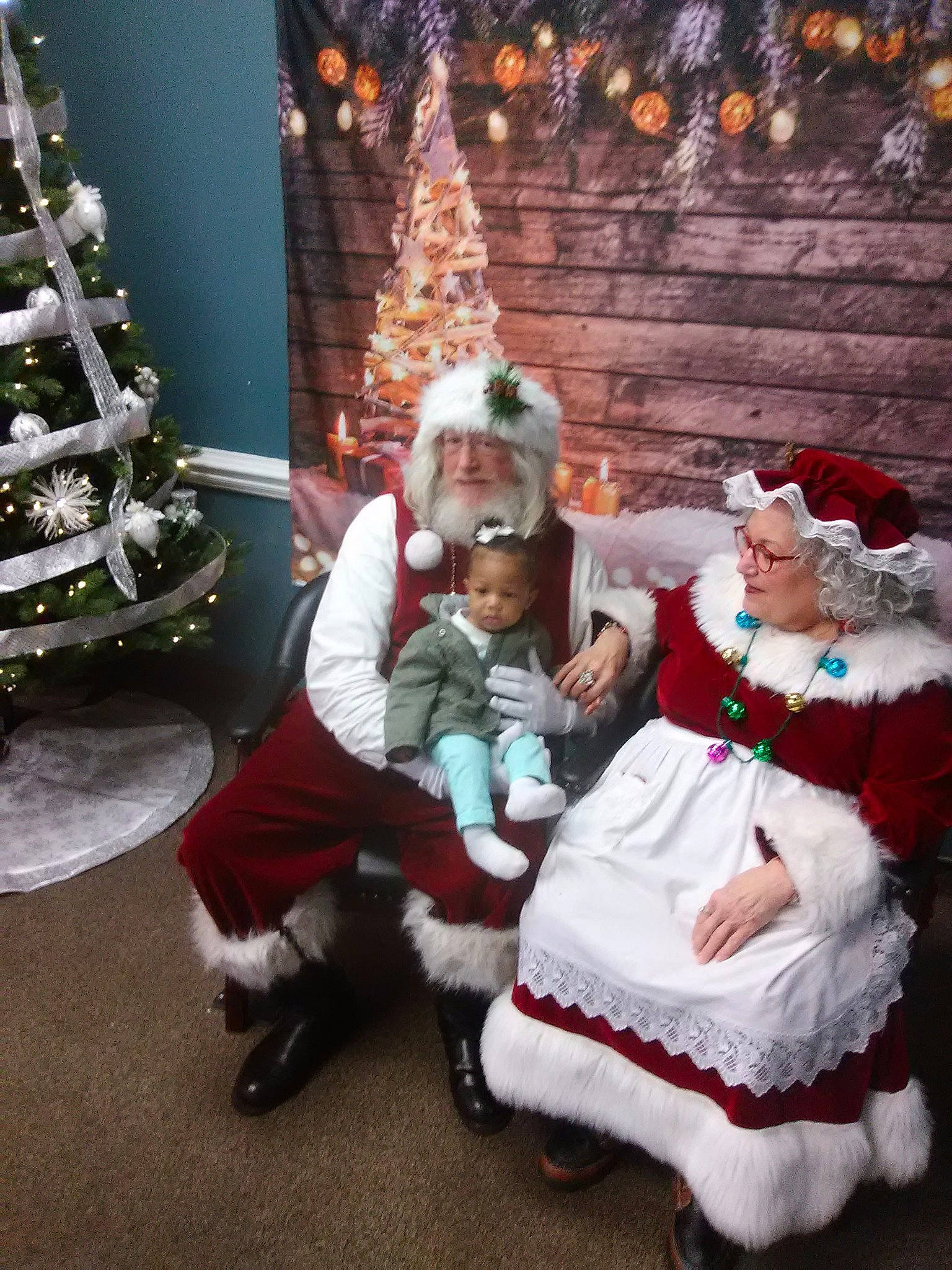 Makiyah is registered to the contest to win money with this photo: christmas, christmas_decoration, christmas_tree, costume, event, fictional_character, fun, holiday, person, santa_claus, tradition