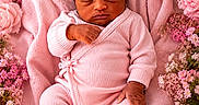 Dior is registered to the contest to win money with this photo: newborn, baby, sleeping, pink_clothing, blanket, flowers, roses, floral_arrangement, soft_texture, peaceful, infant, portrait, cute, cozy, resting, closeup, skin, hand, footwear, indoors