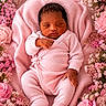 newborn, baby, sleeping, pink_clothing, blanket, flowers, roses, floral_arrangement, soft_texture, peaceful, infant, portrait, cute, cozy, resting, closeup, skin, hand, footwear, indoors