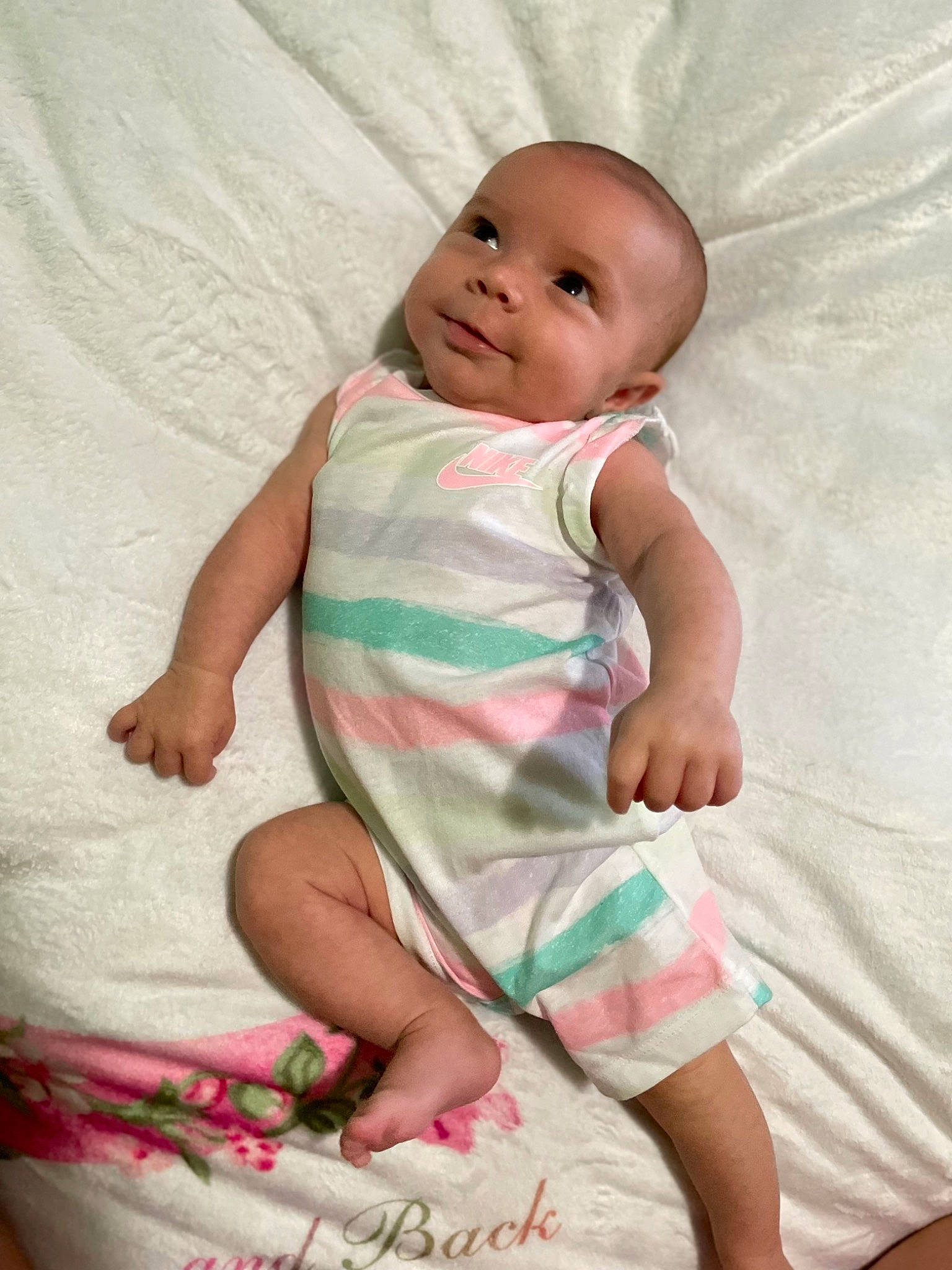 Natalie is registered to the contest to win money with this photo: baby, baby_toddler_clothing, cheek, child, comfort, eye, face, fun, happy, human_leg, linens, pattern, person, pink, sitting, skin, sleeve, smile, textile, thumb