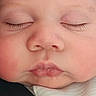 baby, infant, child, sleeping, closed_eyes, face, portrait, close_up, cheeks, nose, mouth, eyelashes, peaceful, cozy, clothing, indoors, photography, head, resting, cute