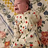 newborn, baby, infant, child, portrait, lying_down, onesie, sleepwear, floral_blanket, blanket, colorful, face, open_mouth, indoors, bed, nursery, cute, patterned_clothing, flowers, photograph