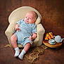 Arlo is registered to the contest to win money with this photo: armchair, art, baby, chair, clothing, cookware, cup, face, furniture, head, hosiery, person, photography, porcelain, portrait, pot, pottery, saucer, sitting, sock