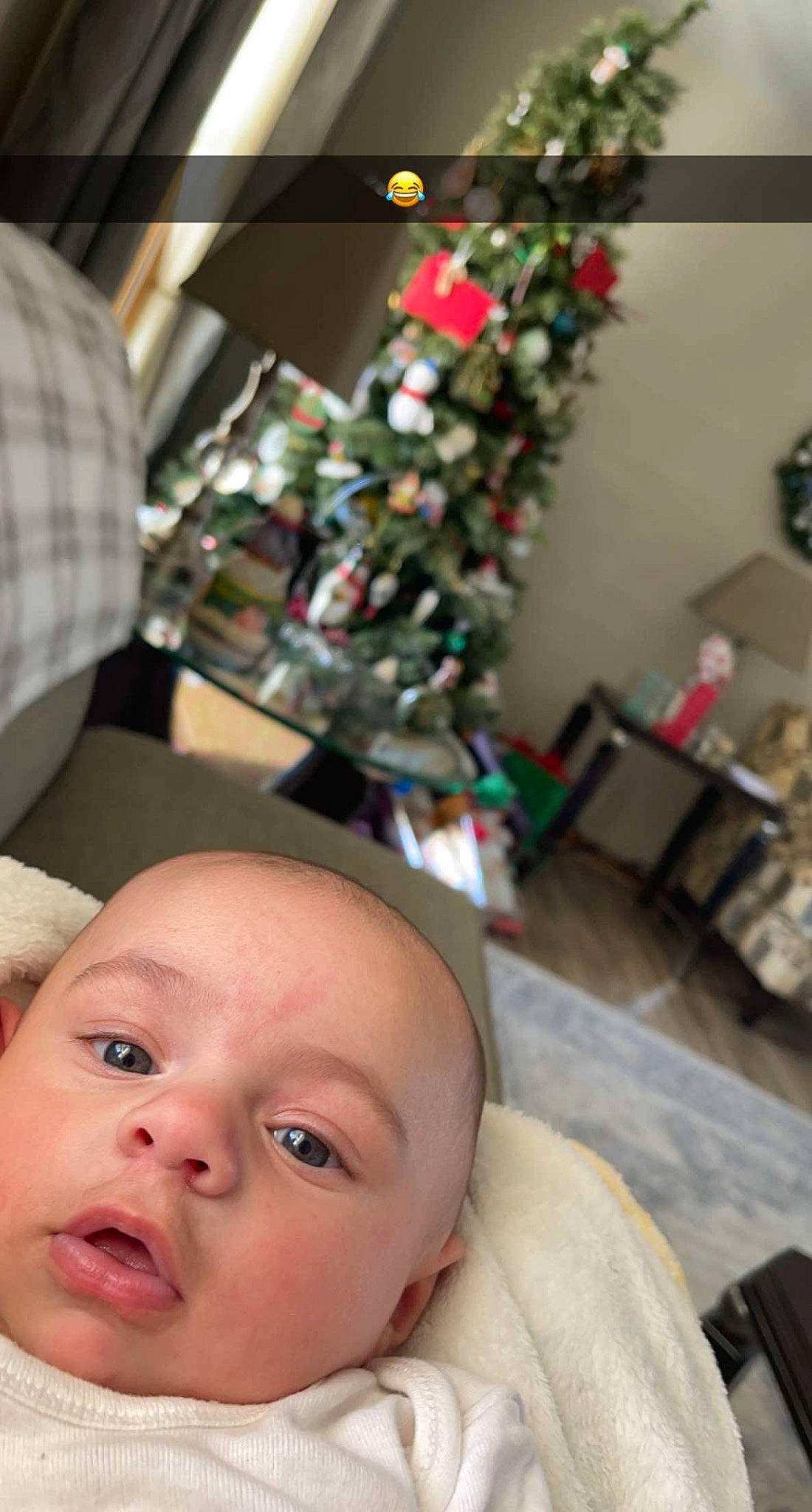 Kash joined the competition — help win amazing prizes! baby, chair, child, christmas, christmas_decoration, christmas_ornament, christmas_tree, event, eyelash, fun, happy, holiday, iris, nose, ornament, person, plant, room, sitting, toddler