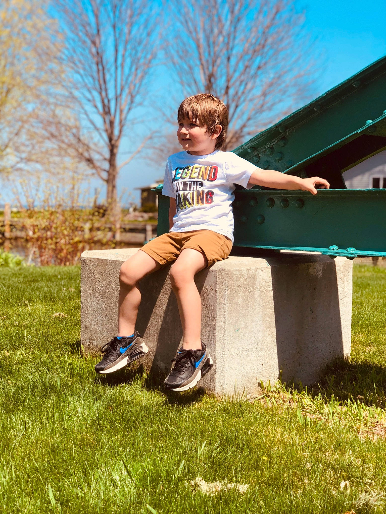 Soren joined the competition — help win amazing prizes! child, fun, grass, grassland, happy, human_leg, lawn, leisure, meadow, people_in_nature, person, plant, recreation, shoe, shorts, sitting, sky, sunlight, t_shirt, toddler