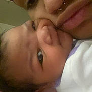 Paradise is registered to the contest to win money with this photo: adult, affection, baby, bonding, child, closeup, cozy, expression, eyes, face, family, head, holding, human, indoor, love, parent, person, portrait, skin