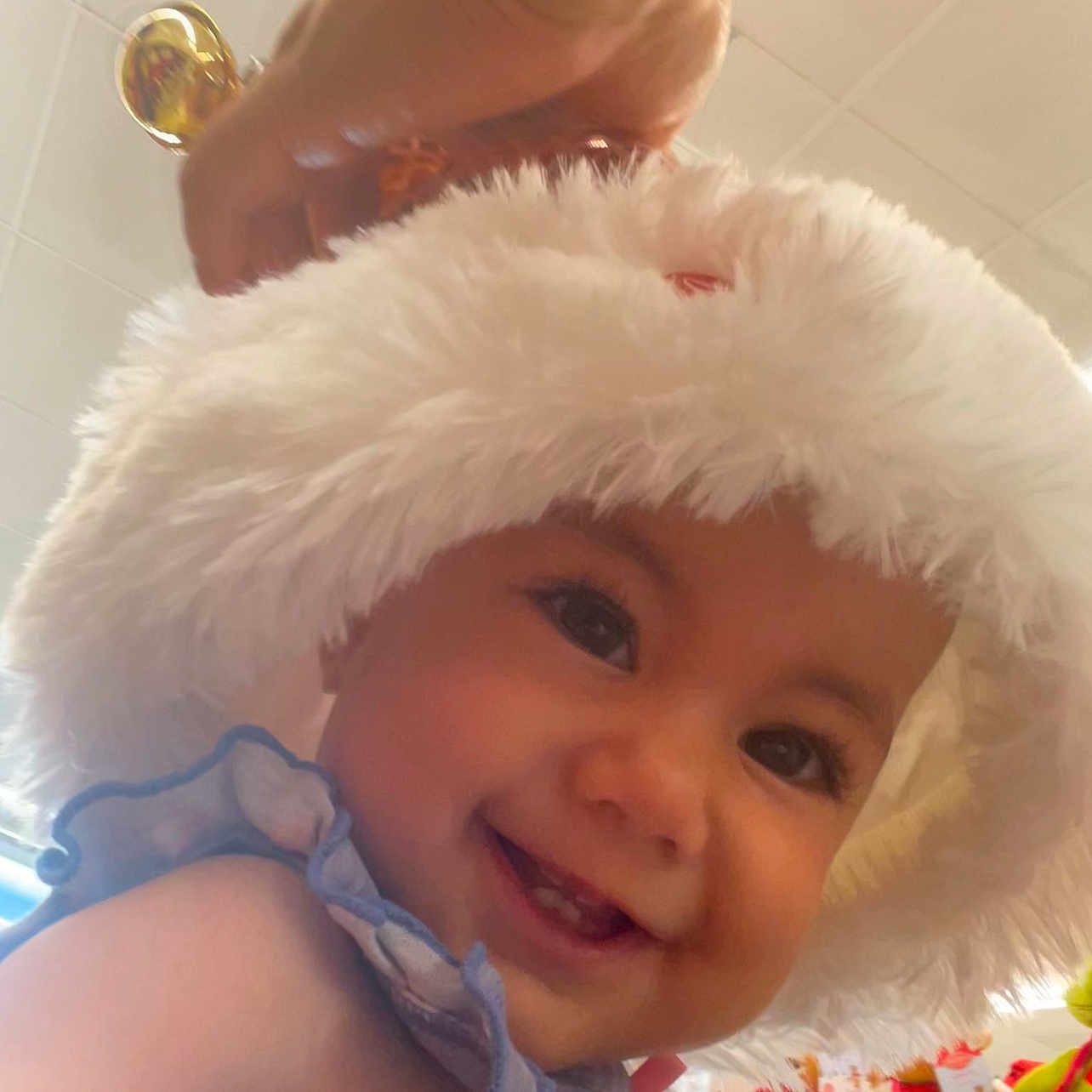 Nenase joined the competition — help win amazing prizes! baby, blue_outfit, child, closeup, colorful, cute, face, fluffy_hat, hand, happy, hat, indoor, infant, person, playful, portrait, ruffles, smiling, tiled_ceiling, toys