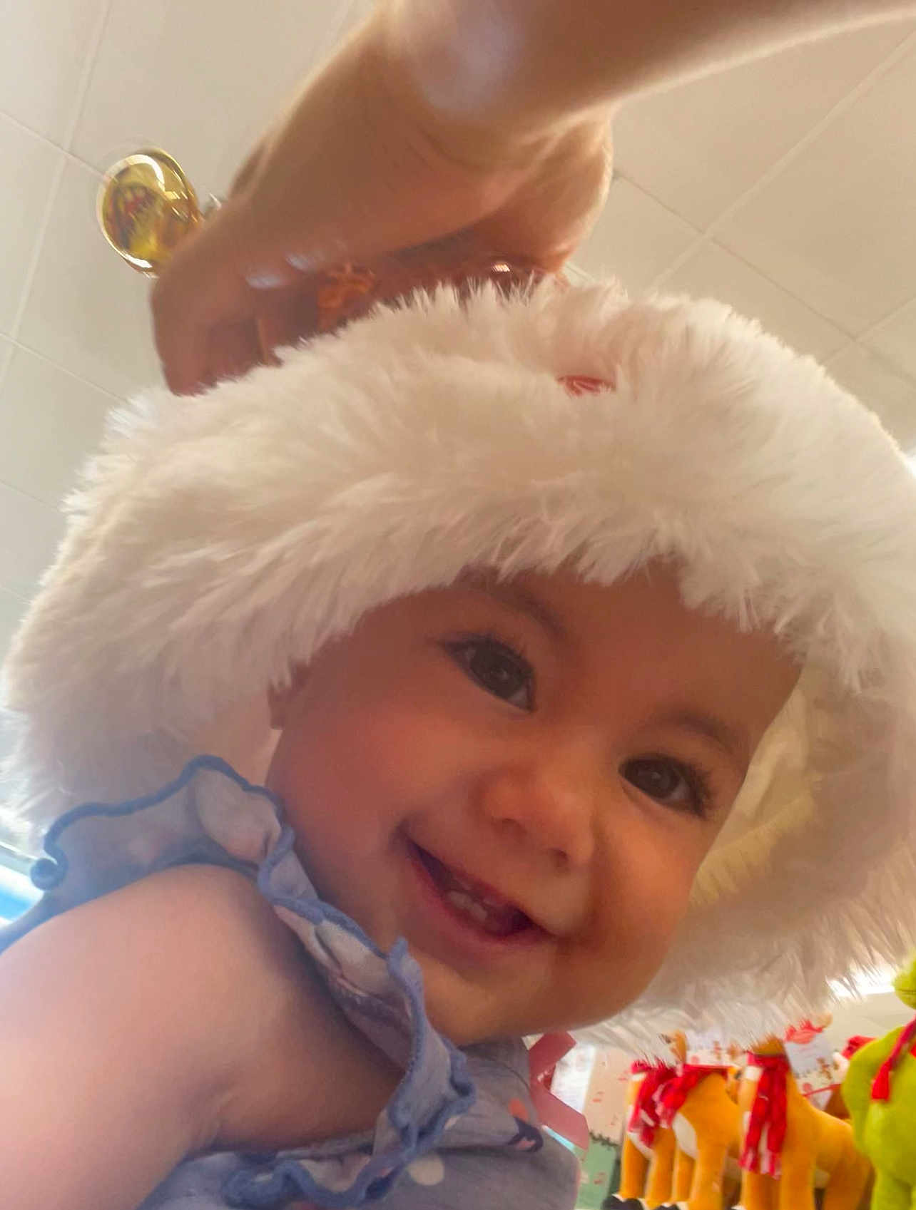 Nenase joined the competition — help win amazing prizes! baby, smiling, hat, fluffy_hat, child, cute, indoor, portrait, face, hand, blue_outfit, playful, happy, toys, colorful, tiled_ceiling, closeup, person, infant, ruffles