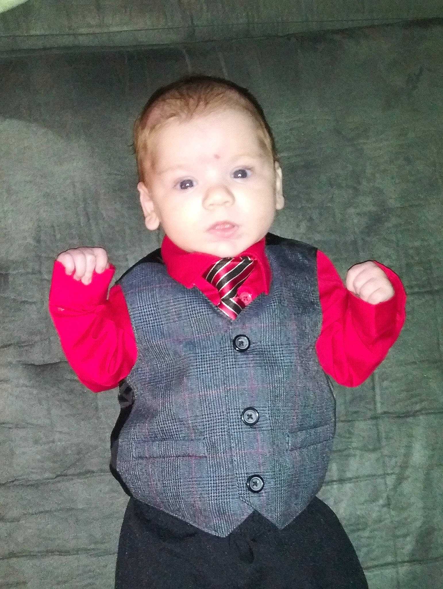 Liam is registered to the contest to win money with this photo: baby_toddler_clothing, cheek, chin, collar, dress_shirt, flash_photography, formal_wear, gesture, hair, hand, lip, neck, nose, outerwear, pattern, person, skin, sleeve, standing, tartan