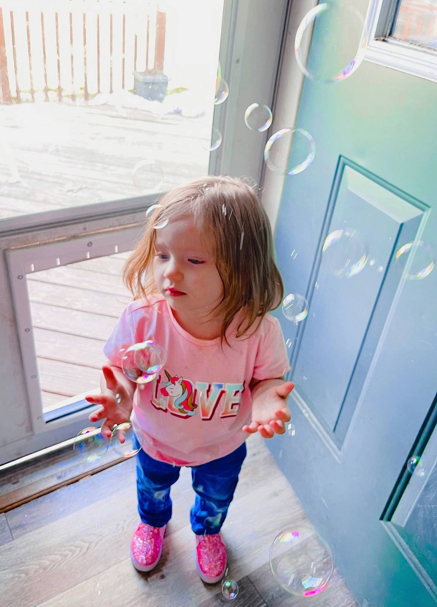 Audrey is registered to the contest to win money with this photo: baby_toddler_clothing, child, cool, door, electric_blue, fun, happy, home_door, leisure, magenta, person, pink, play, sandal, sleeve, standing, t_shirt, tints_and_shades, toddler, vacation