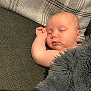 Lilly is registered to the contest to win money with this photo: baby, sleeping, blanket, couch, pillow, plaid, infant, peaceful, nap, soft, skin, face, arm, indoors, cozy, closeup, rest, relaxation, child, furniture