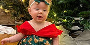 Kaia joined the competition — help win amazing prizes! baby, bow, child, christmas_tree, cute, decorations, festive_clothing, floor, greenery, happy, headband, holiday, indoors, lights, red_shoes, seasonal, sitting, smiling, toddler, wooden_floor