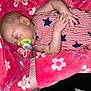 baby, sleeping, pacifier, blanket, red, blue, striped_clothing, stars, infant, hand, face, head, skin, cute, rest, cozy, floral_pattern, soft, comfort, nap