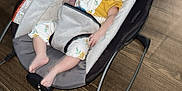 Kaia is registered to the contest to win money with this photo: baby, sleeping, infant, baby_rocker, headband, yellow, floral_outfit, indoor, wooden_floor, footwear, child, resting, comfort, soft_lighting, casual, relaxation, home, furniture, peaceful, young_child