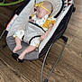 baby, sleeping, infant, baby_rocker, headband, yellow, floral_outfit, indoor, wooden_floor, footwear, child, resting, comfort, soft_lighting, casual, relaxation, home, furniture, peaceful, young_child
