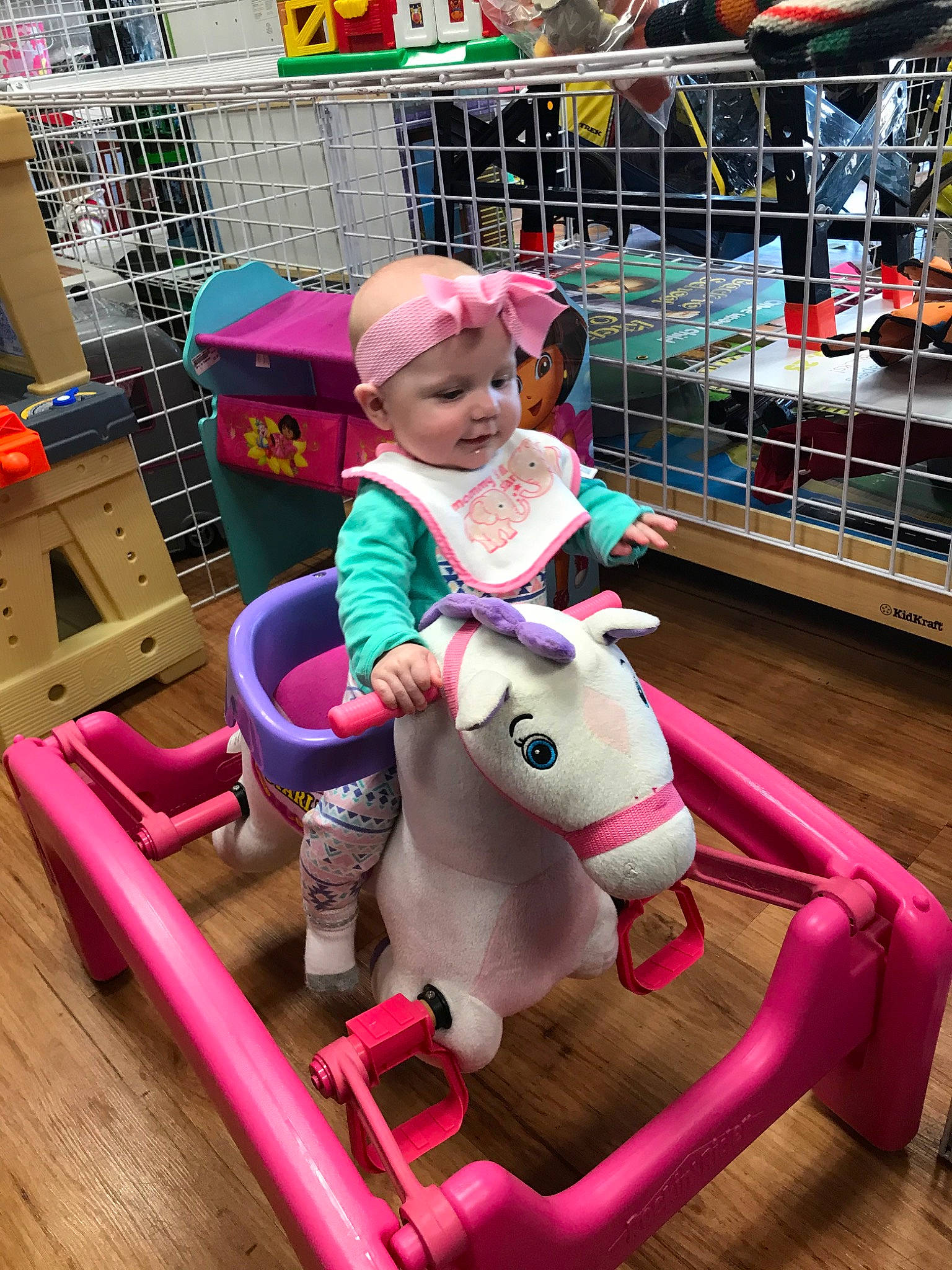 Gracie Rae is registered to the contest to win money with this photo: child, fun, horse, magenta, person, pink, play, playground, playset, pony, public_space, recreation, toddler, toy, vacation