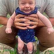 Oliver joined the competition — help win amazing prizes! baby, child, smiling, person, hands, boots, red_boots, outdoor, plants, grass, blue_outfit, fireworks_pattern, legs, feet, adult, casual_clothing, nature, funny, cute, portrait