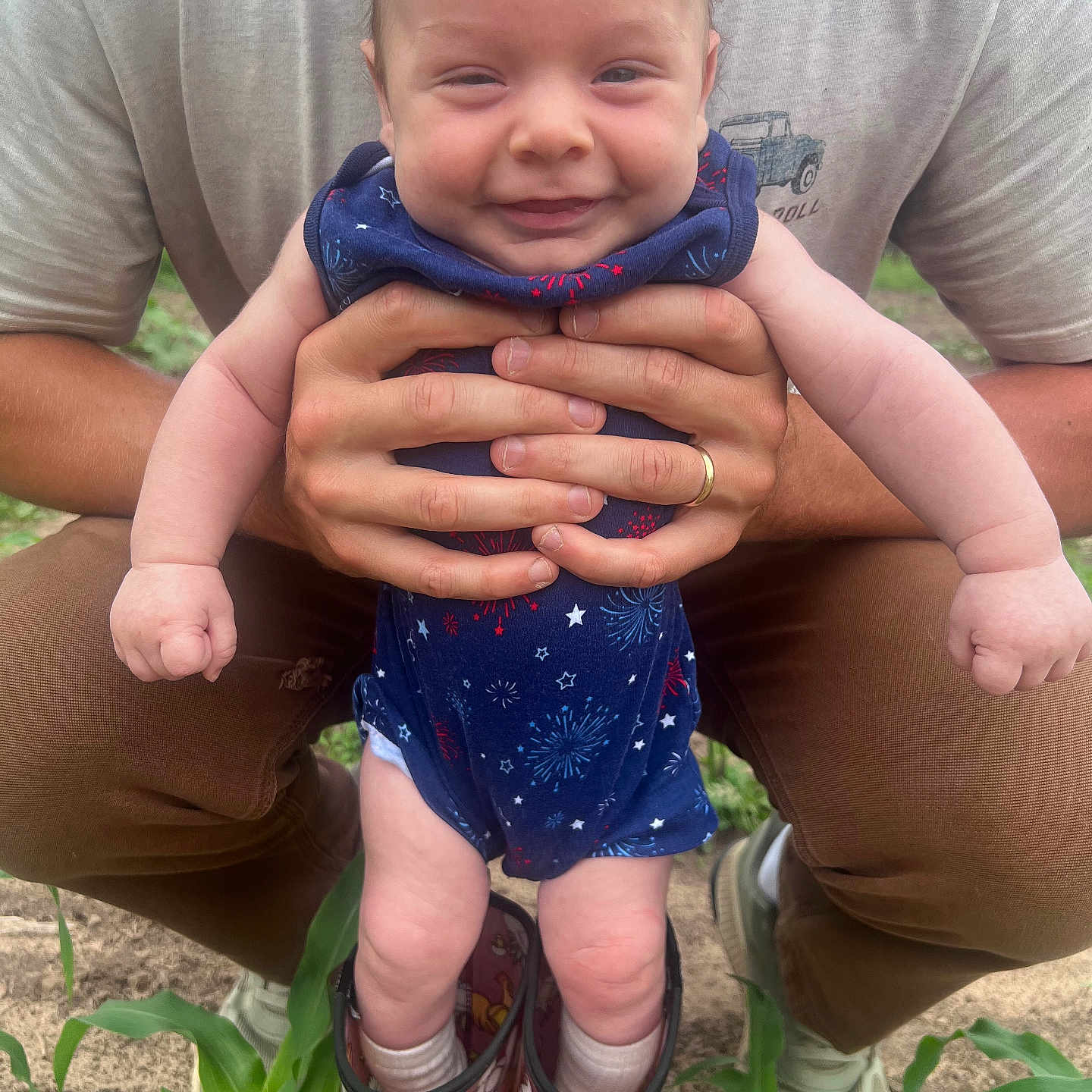 Oliver joined the competition — help win amazing prizes! baby, child, smiling, person, hands, boots, red_boots, outdoor, plants, grass, blue_outfit, fireworks_pattern, legs, feet, adult, casual_clothing, nature, funny, cute, portrait