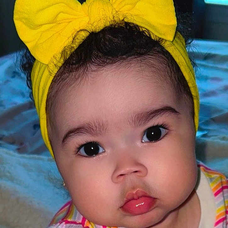 Kiari joined the competition — help win amazing prizes! baby, child, portrait, headband, yellow_bow, striped_shirt, curious_eyes, pouty_lips, closeup, indoor, soft_lighting, cute, infant, face, young_child, adorable, expression, fashion, colorful_clothing, person