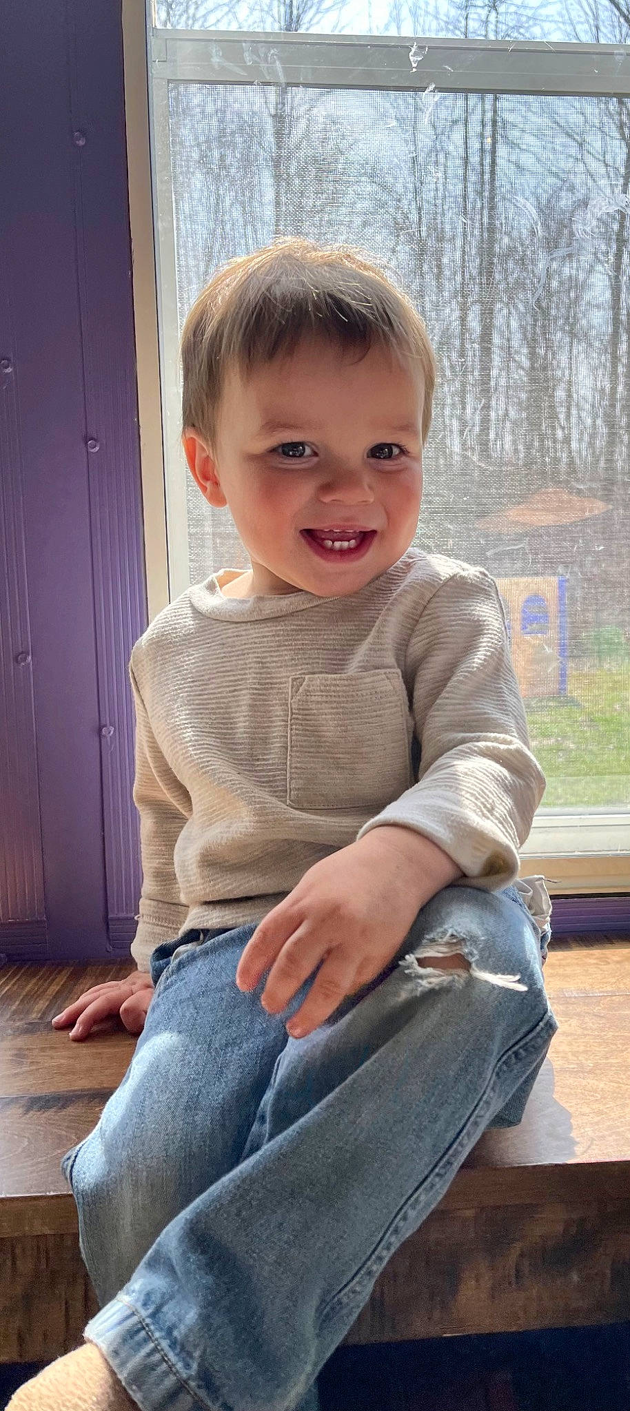 Lawson is registered to the contest to win money with this photo: baby_toddler_clothing, door, facial_expression, flooring, grass, hair, hairstyle, happy, head, jeans, joint, joy, knee, person, skin, sleeve, smile, standing, t_shirt, thigh