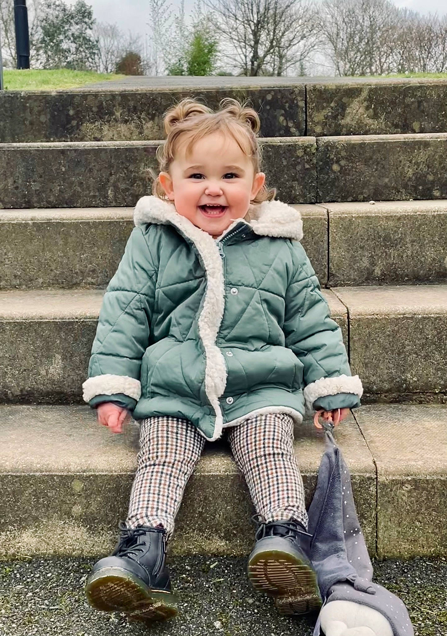 Isla-mae is registered to the contest to win money with this photo: baby_toddler_clothing, cheek, child, cool, eye, flash_photography, fun, grass, happy, iris, joy, leisure, people_in_nature, person, shoe, sitting, skin, sleeve, smile, sneakers