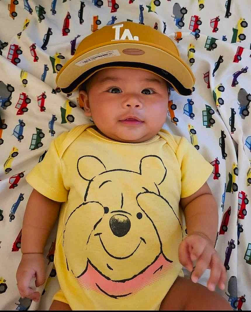 Luther joined the competition — help win amazing prizes! baby, baby_toddler_clothing, cap, cheek, child, facial_expression, fun, hairstyle, happy, headwear, pattern, people, person, pink, product, skin, sleeve, t_shirt, textile, toddler