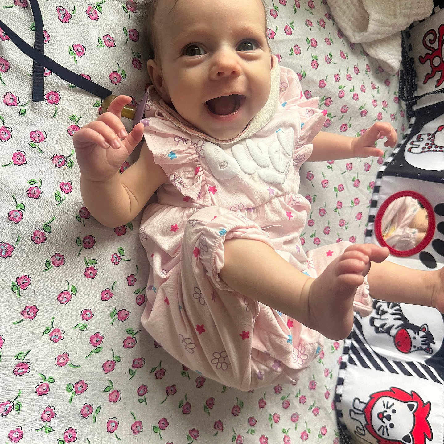 Vivian joined the competition — help win amazing prizes! baby, babylaughing, bed, bodypart, clothing, dress, face, finger, furniture, hand, happy, head, laughing, person, photography, portrait, quilt, sitting, smile, t_shirt