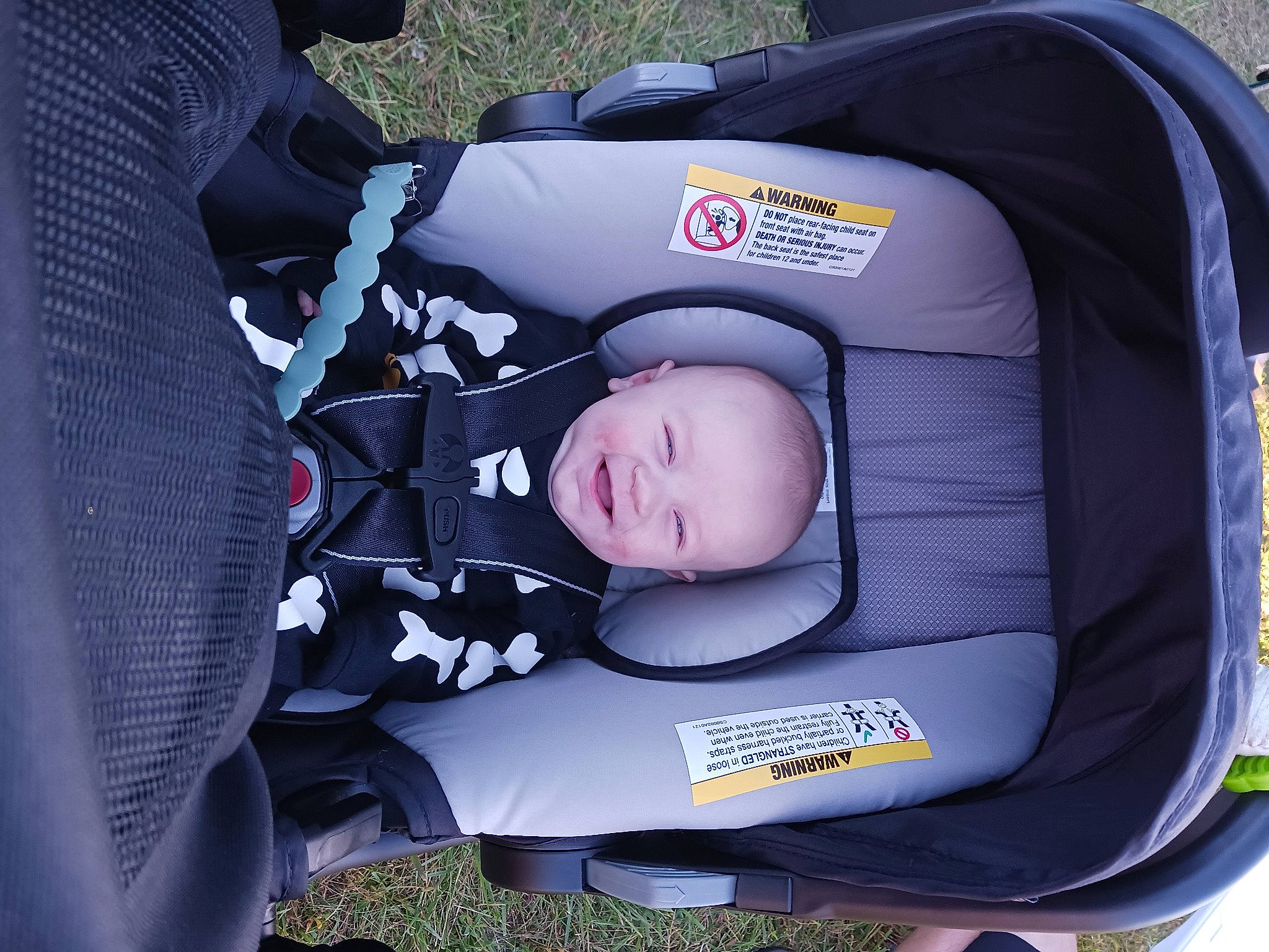 Harrison is registered to the contest to win money with this photo: auto_part, automotive_design, automotive_tire, baby, baby_carriage, baby_products, baby_safety, baby_toddler_clothing, car_seat, car_seat_cover, child, comfort, electric_blue, grass, joy, motor_vehicle, person, plant, toddler, vehicle