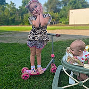 Paislee joined the competition — help win amazing prizes! child, baby, girl, scooter, walker, grass, outdoor, play, leopard_print, shorts, shoes, headband, pout, pose, summer, daylight, curious, greenery, toys, fun