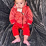 Gavin is registered to the contest to win money with this photo: alert, baby, bare_feet, casual_clothing, child, curious_expression, cute, face, gray_blanket, hoodie, indoor, infant, pants, portrait, red_clothing, sitting, small_hands, soft_surface, texture, young_child