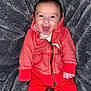 Gavin is registered to the contest to win money with this photo: baby, blanket, casual_wear, child, cute, face, happy, hoodie, human, indoor, infant, one_person, pants, portrait, red_clothing, sitting, smiling, texture, warm_clothing, young_child