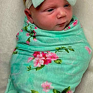 Maizley is registered to the contest to win money with this photo: baby, newborn, infant, swaddle_blanket, headband, bow, floral_pattern, mint_green, pink, wrapped, portrait, close_up, rosy_cheeks, sleepy, cute, adorable, soft_texture, bedding, blanket, nursery