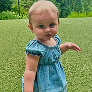 Isabella is registered to the contest to win money with this photo: toddler, child, blue_dress, grass, outdoor, nature, greenery, barefoot, portrait, curious, baby, standing, summer, daylight, park, trees, lamp_post, cute, young_child, innocence
