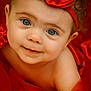 baby, child, portrait, face, blue_eyes, smile, headband, jewel, red_fabric, close_up, cute, infant, soft_lighting, skin, curly_hair, adorable, expression, warm_colors, fashion, young