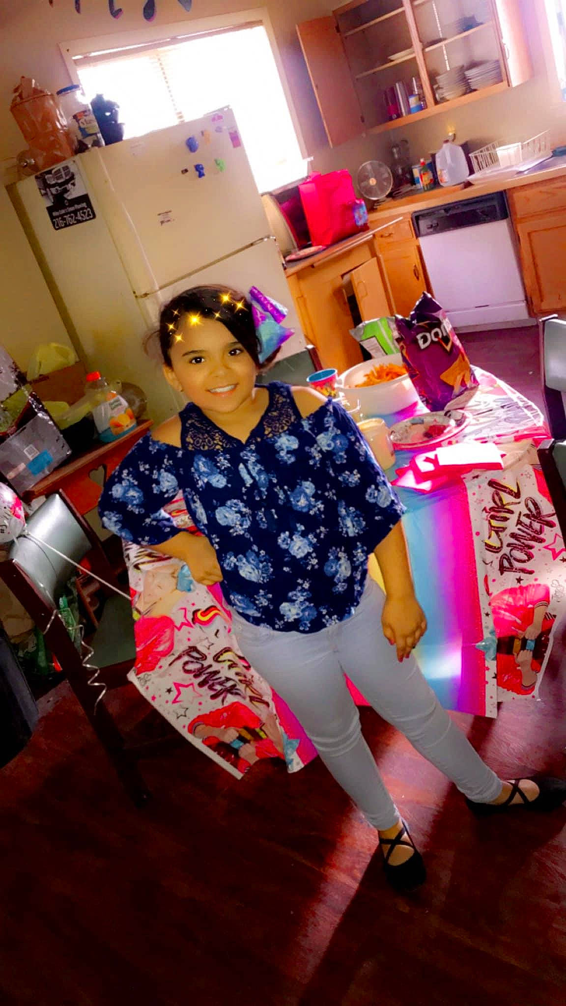 Miracle is registered to the contest to win money with this photo: event, fashion_design, flooring, fun, happy, houseplant, human_leg, interior_design, joy, knee, lamp, leisure, magenta, person, pink, room, sandal, shoe, smile, t_shirt