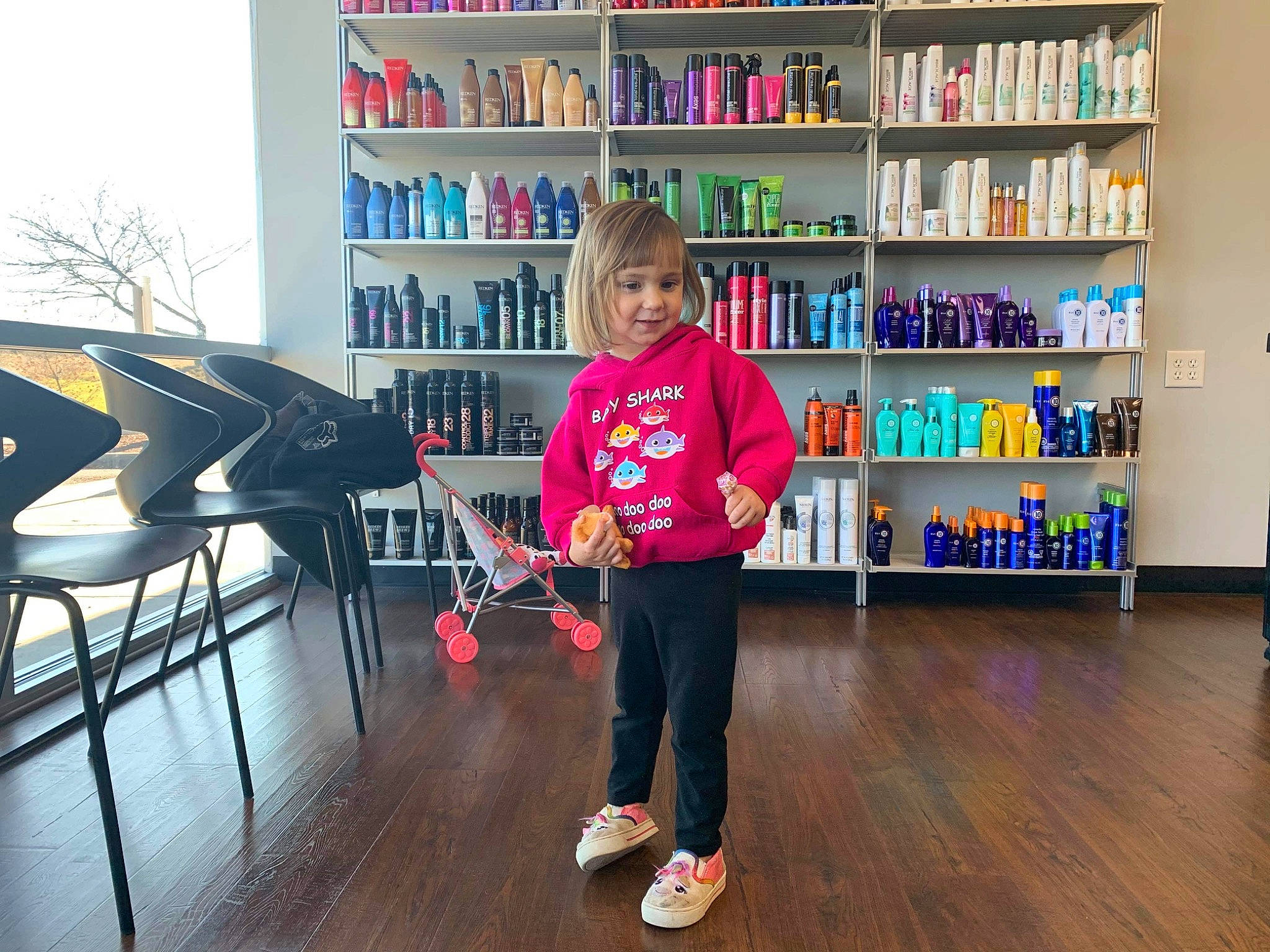 Adyson is registered to the contest to win money with this photo: bookcase, building, child, floor, flooring, footwear, fun, furniture, joy, library, person, play, product, public_library, shelf, shelving, shoe, standing, toddler, wood