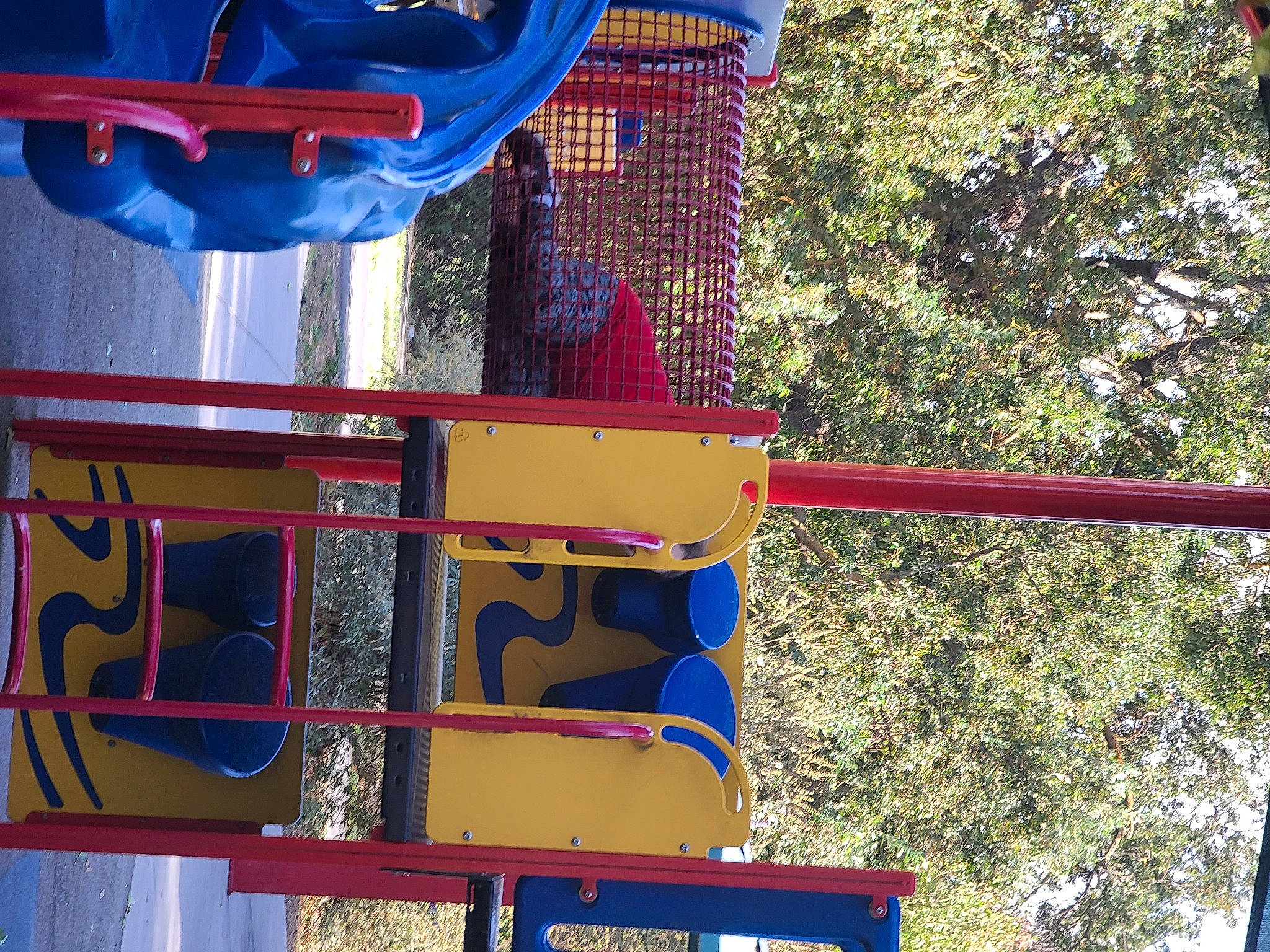 Scarlette is registered to the contest to win money with this photo: amusement_park, amusement_ride, carmine, city, electric_blue, fun, leisure, light, nonbuilding_structure, outdoor_play_equipment, person, public_space, recreation, red, shade, transport, tree, water