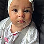 Leya participe au concours pour gagner de l'argent avec cette photo : baby, child, face, headband, bow, white_clothing, sweater, car_seat, seatbelt, closeup, portrait, infant, cute, young_child, person, straps, pink_pattern, looking, indoors, expression