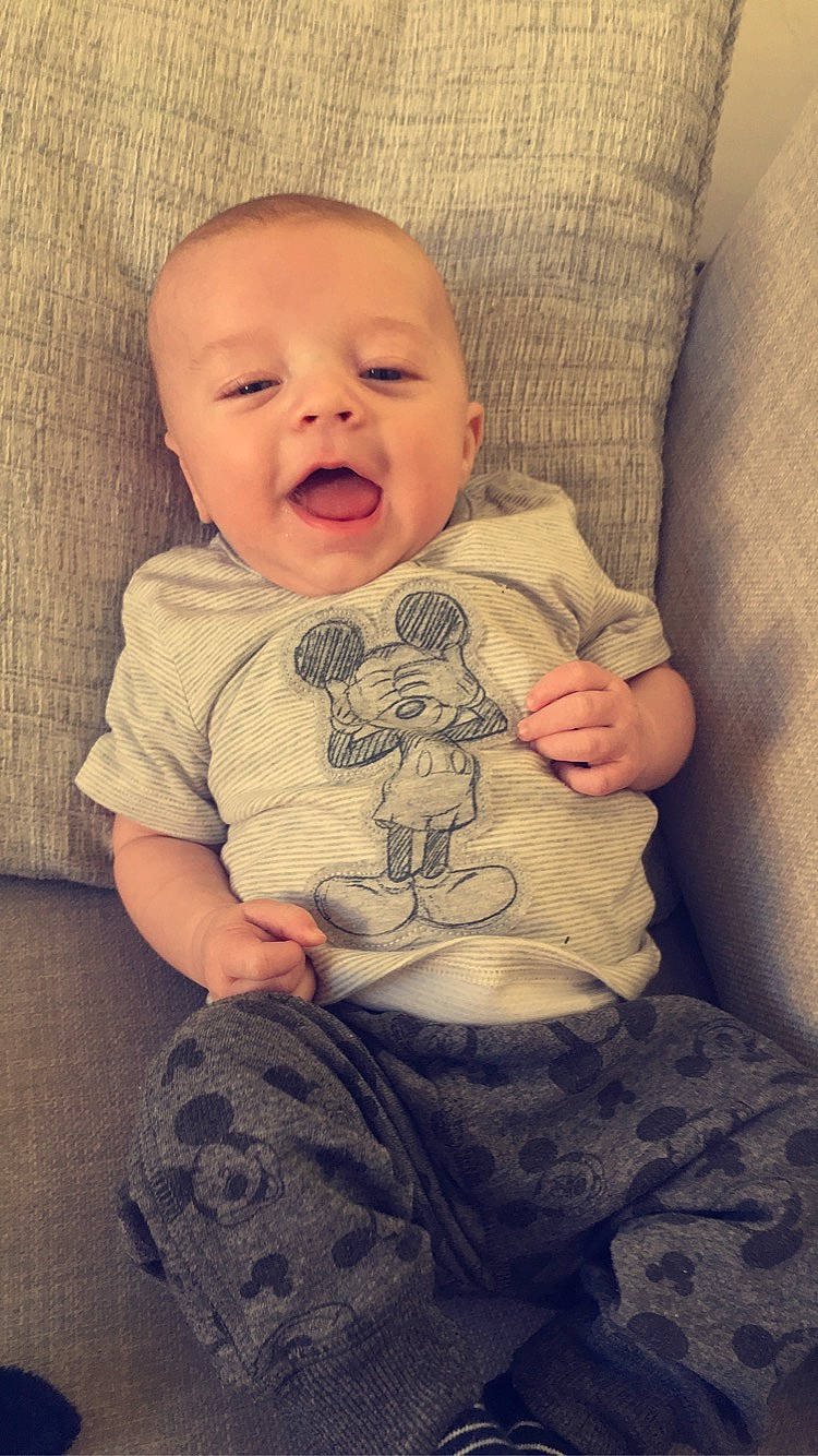 Jaxson is registered to the contest to win money with this photo: arm, baby, cheek, child, head, person, sitting, sleeve, smile, toddler