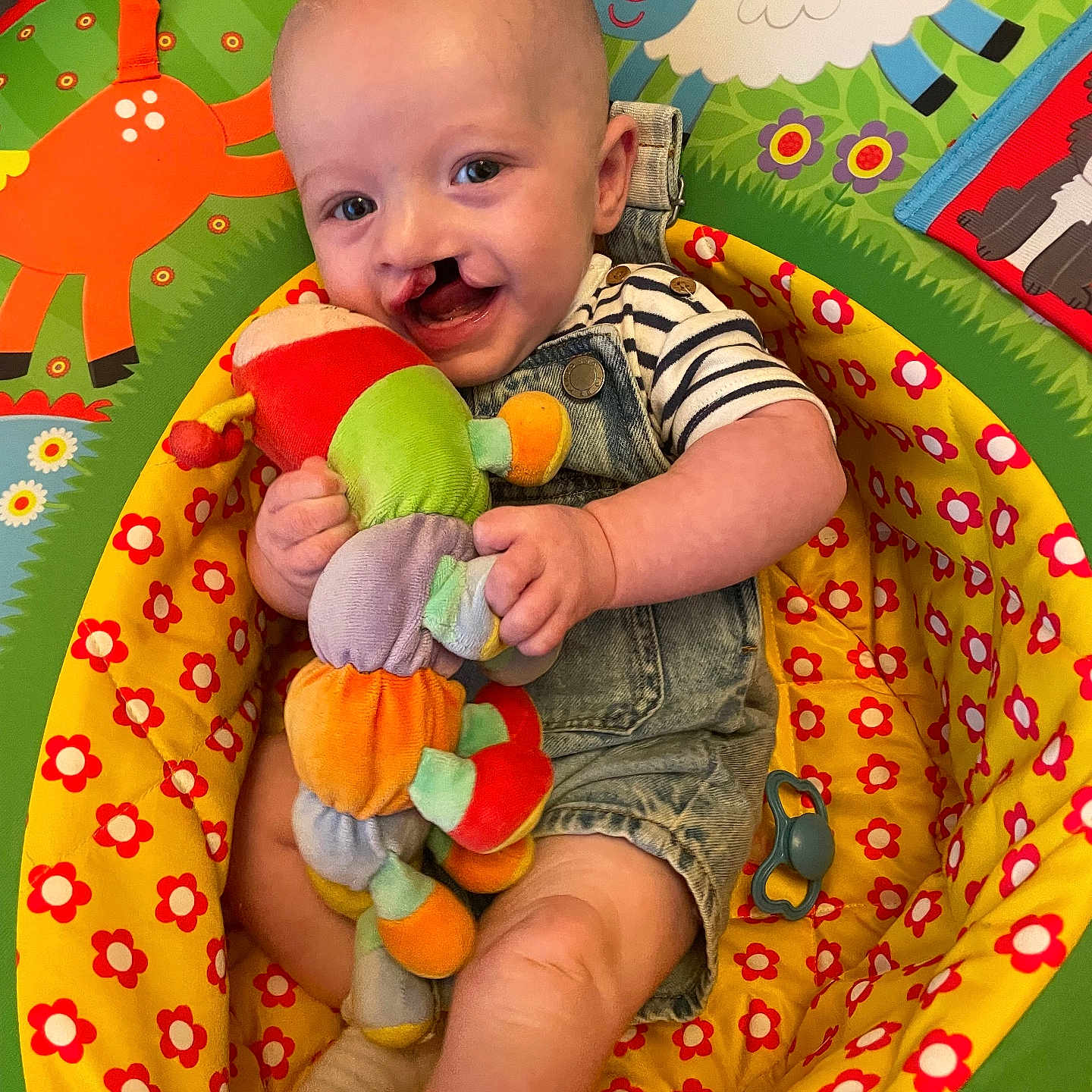 Kai is registered to the contest to win money with this photo: baby, bed, blanket, clothing, cushion, face, furniture, happy, head, homedecor, newborn, person, photography, portrait, quilt, sitting, smile, summer, t_shirt, toy