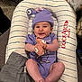 Emerson joined the competition — help win amazing prizes! baby, smiling, purple_clothing, hat, plush_toy, cushion, dockatot, striped, infant, happy, cute, indoor, feet, hands, face, person, child, relaxing, seated, cozy
