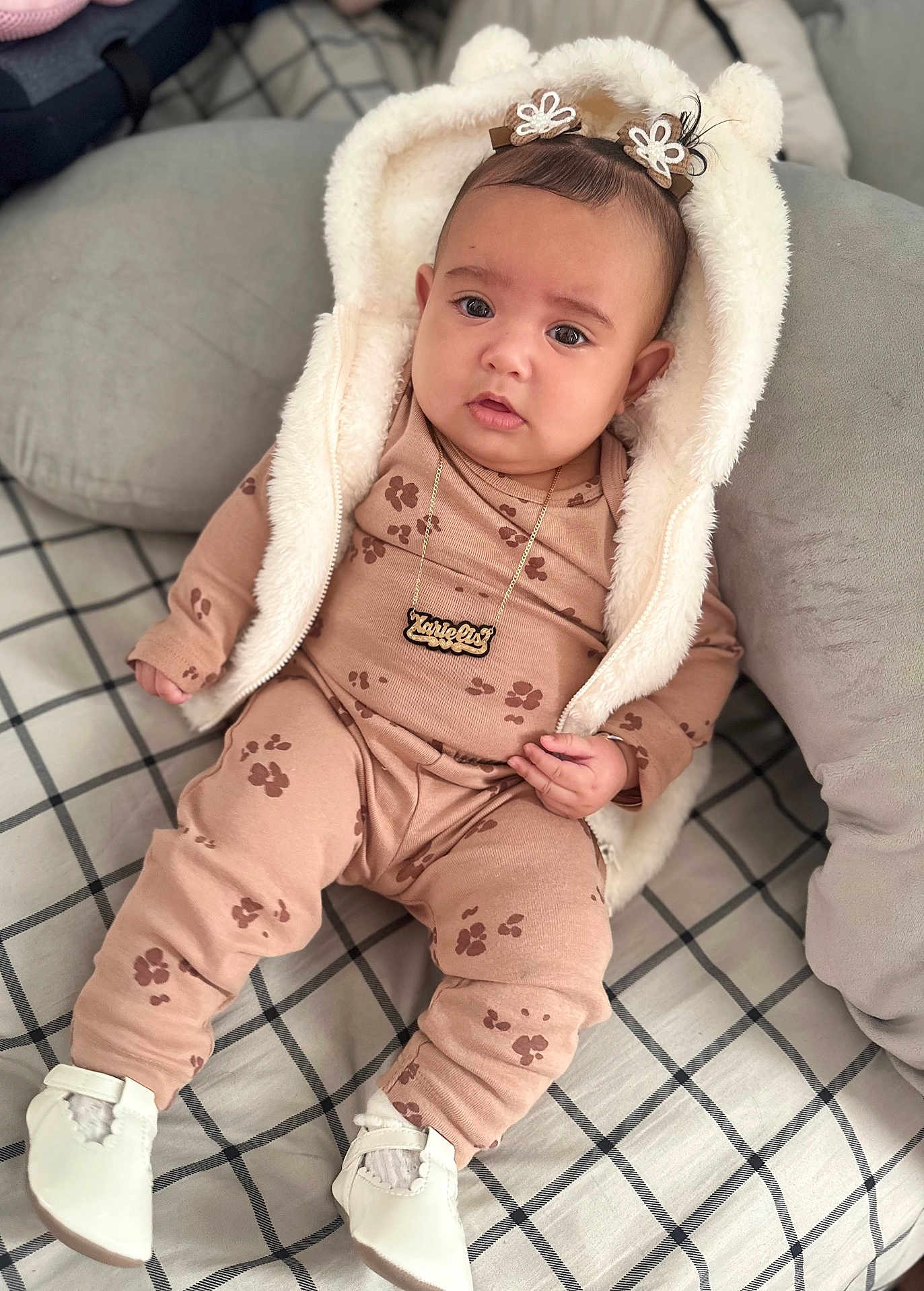 Xarielis joined the competition — help win amazing prizes! baby, child, infant, pajamas, hood, bear_ears, necklace, white_shoes, blanket, pillow, indoor, cute, cozy, portrait, sitting, pattern, clothing, soft_fabric, relaxed, home