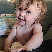 Steelie joined the competition — help win amazing prizes! baby, child, blue_eyes, curly_hair, plush_toy, couch, cushion, indoors, smiling, happy, skin, arm, hand, person, portrait, infant, cute, toddler, expression, closeup