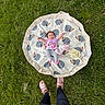 Evangeline joined the competition — help win amazing prizes! baby, child, grass, outdoor, mat, hedgehog_pattern, pink_crocs, legs, toy, blanket, playtime, happy, infant, nature, person, cute, smile, casual, relaxation, daylight