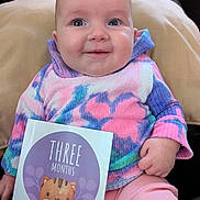 Magdalena is registered to the contest to win money with this photo: baby, infant, smiling, sweater, pink_pants, milestone_card, three_months, cat_illustration, cushion, cozy, portrait, child, cute, indoors, hand, face, clothing, seated, happy, young