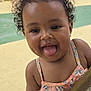 toddler, child, curly_hair, smiling, tongue_out, popsicle, summer, outdoor, playground, trees, sunny, people, dress, happy, fun, daytime, skin, person, holding, blurred_background