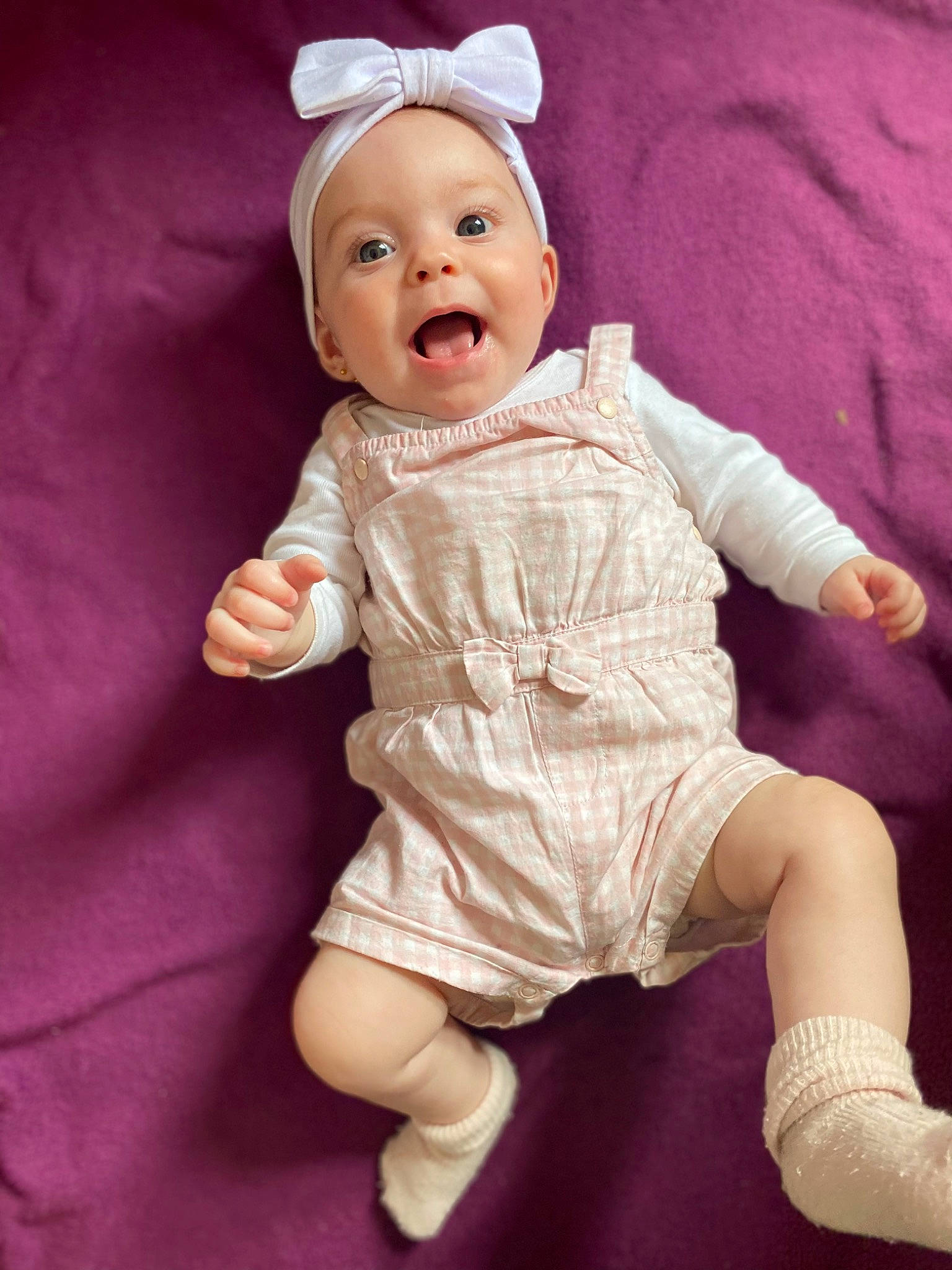 Amaia participe au concours pour gagner de l'argent avec cette photo : baby, baby_toddler_clothing, cheek, eye, face, finger, hand, happy, head, lip, magenta, person, pink, purple, skin, sleeve, smile, surprise, thigh, thumb