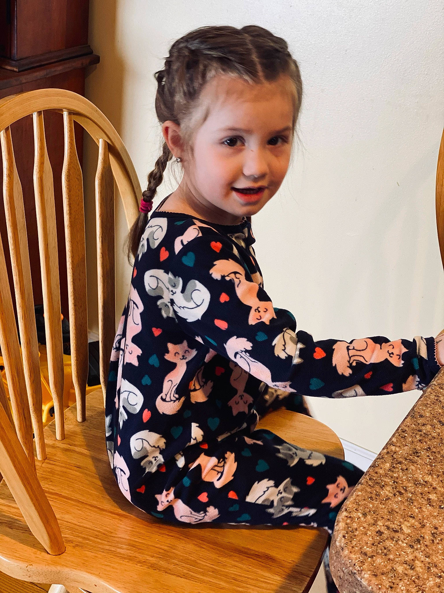 Dahlia is registered to the contest to win money with this photo: baby_toddler_clothing, chair, child, comfort, hardwood, human_body, neck, pattern, people, person, play, room, sitting, sleeve, smile, t_shirt, table, tableware, toddler, windsor_chair
